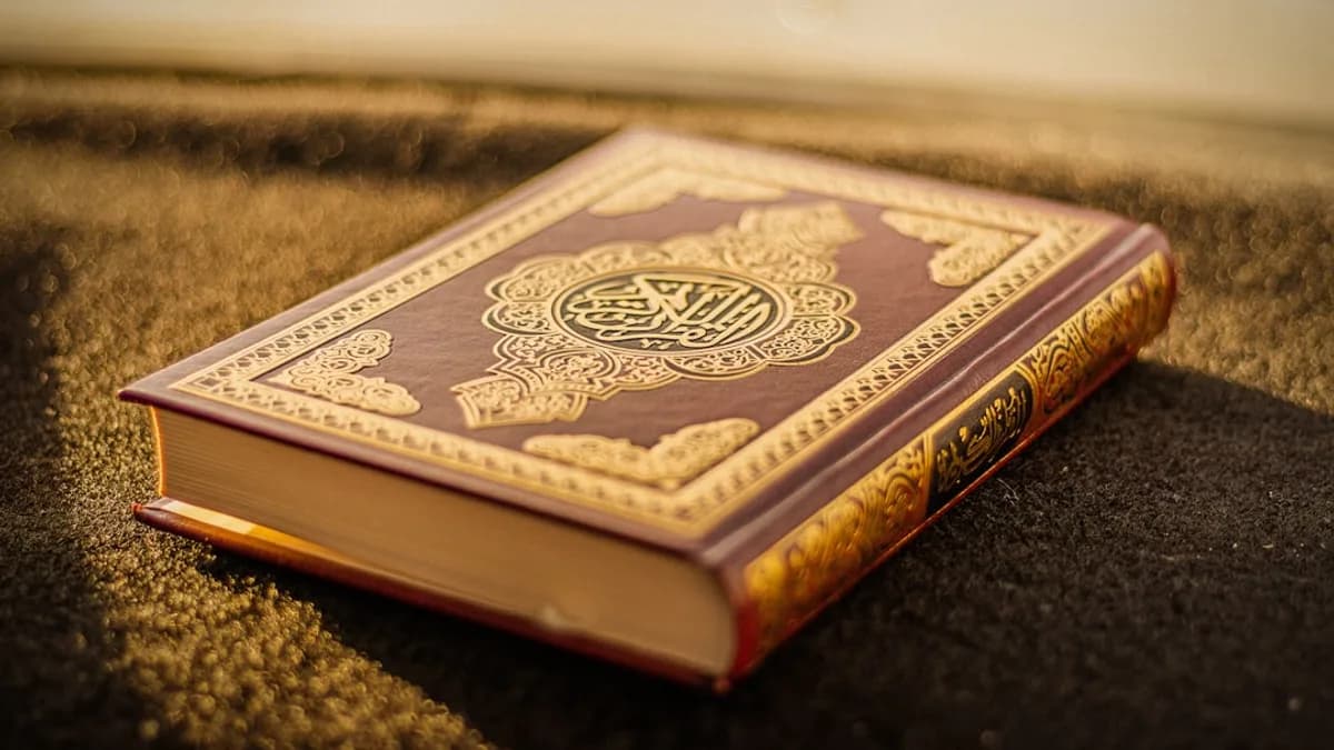 Muslim reader comparing an Arabic Quran page with an English translation edition