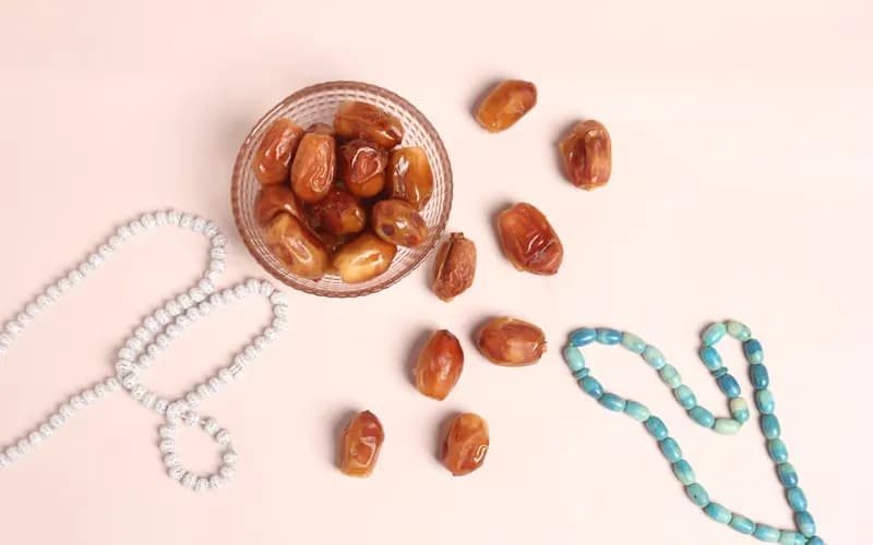 Family gathering around a table with dates and food to break the Ramadan fast at Iftar